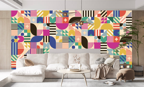 A modern living room with a beige sofa and round coffee table is set against Cover-Alls’ Bauhaus Tile Wallpaper, creating vibrant energy—ideal for anyone looking for striking tile wallpaper or contemporary wallpaper rolls.