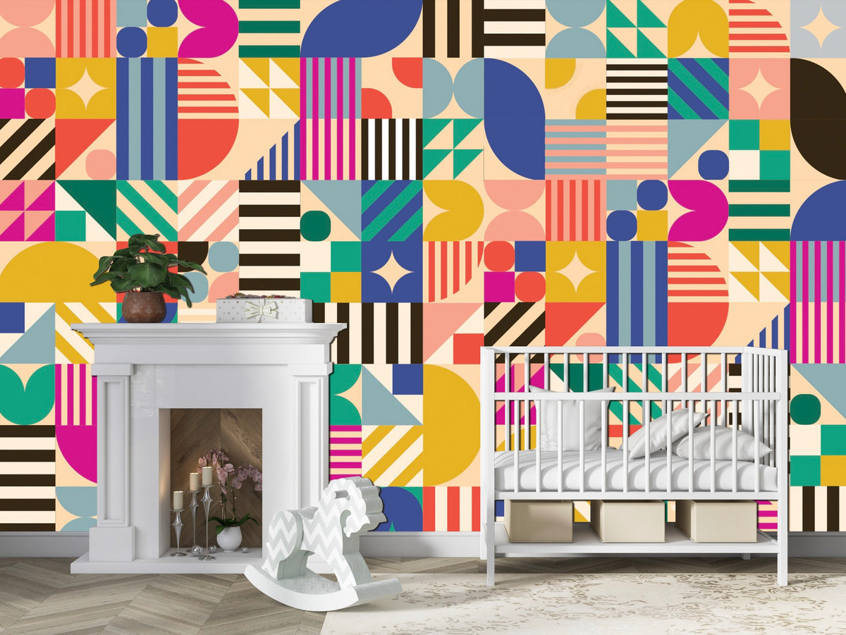 A nursery with a white crib, modern white fireplace, wooden rocking horse, and the wall covered in Cover-Alls’ Bauhaus Tile Wallpaper featuring a bold geometric pattern.