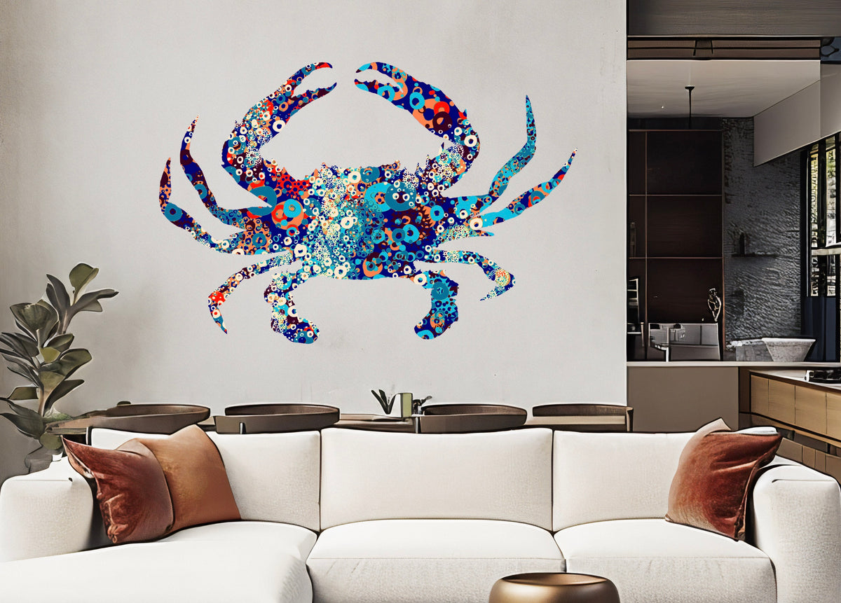 A living room featuring Cover-Alls' Abstract Blue Crab Wall Art on the wall. A white sofa adorned with orange cushions sits amidst lush green plants, with a modern kitchen visible in the background. The sophisticated design seamlessly blends vibrant colors and chic elements.