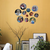 Collection of Cover-Alls Custom Photo Circle Decals on a mustard-colored photo wall, displaying diverse personal photos, above assorted framed art prints and plants in a cozy interior.