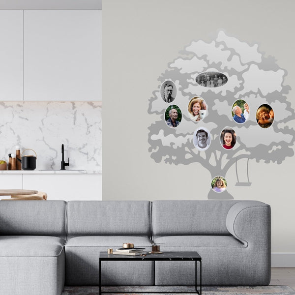 A modern living room with a Cover-Alls Family Tree Wall Decal with Custom Photos featuring diverse people on a light gray wall.