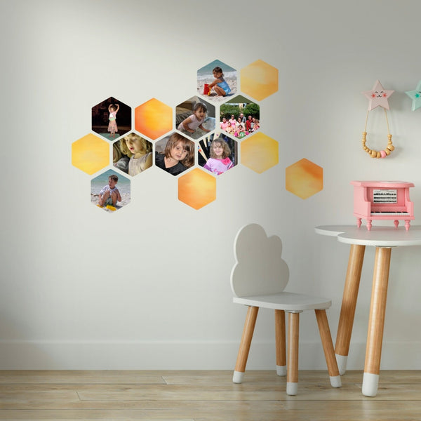 Cover-Alls honeycomb or hexagon shaped decals with diverse images on a wall, accompanied by a small table and chair with a toy piano and decorations.