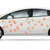 White car with orange and beige Cover-Alls Dot Decals on its body, displayed in profile view on a white background.