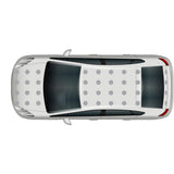Top view of a white car with a black roof and Cover-Alls Dot Decals, parked, showing no visible surroundings.