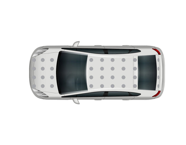 Top view of a white car with a black roof and Cover-Alls Dot Decals, parked, showing no visible surroundings.
