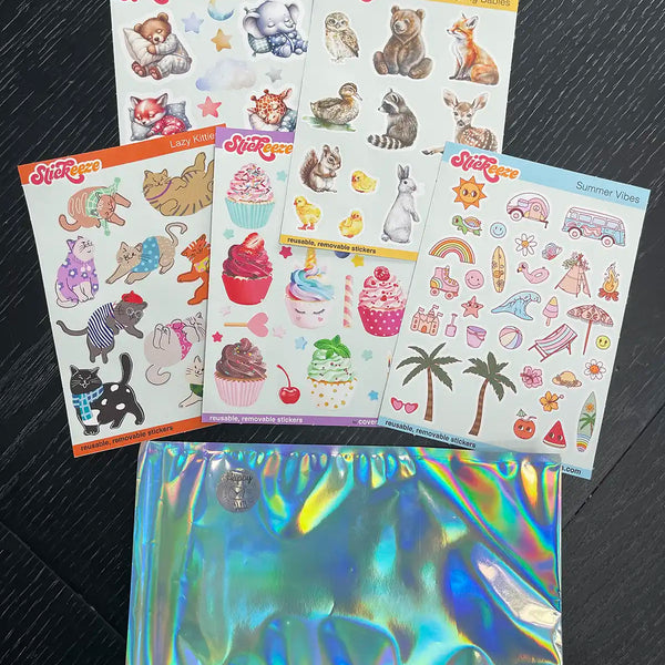 A collection of colorful, easy-peel Stickeeze Kid's Sticker Club sheets with various themes, including cute animals and summery icons, displayed beside a shiny holographic pouch on a dark surface.