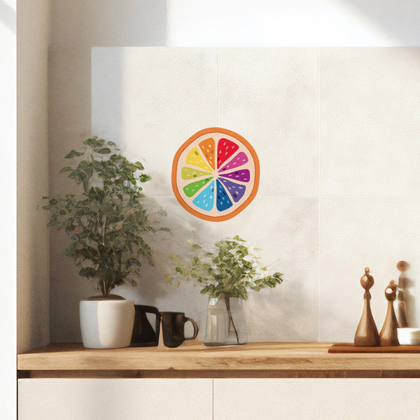 A wooden countertop with two potted plants, two black mugs, and a pair of wooden salt and pepper shakers. A Slice of the Rainbow decal by Cover-Alls adds a burst of color to the white wall in the background.