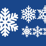 Five Cover-Alls Snowflake Decals of different shapes and sizes decorate a blue background, creating a wintry scene.