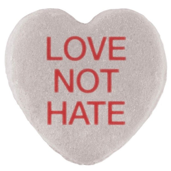 Heart-shaped Candy Hearts with the phrase "love not hate" printed in red text, perfect for Valentine's Day, by Cover-Alls.