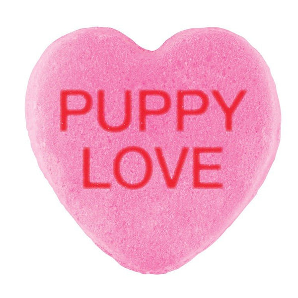 A pink heart-shaped Candy Hearts with the phrase "puppy love" embossed in red letters, featuring a custom design for Valentine's Day by Cover-Alls.