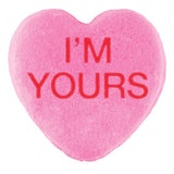 A pink heart-shaped candy with the phrase 