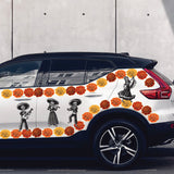 White Day of the Dead Mariachi Band SUV with colorful Dia de Los Muertos-themed decals, featuring sugar skulls and orange flowers, parked beside a gray wall. Brand name: Cover-Alls.