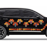 A black car decorated with colorful Day of the Dead Painted Skull Calaveras graphics and floral patterns on its side by Cover-Alls.