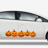 A white sedan decorated with a row of Cover-Alls Jack O' Lantern Pumpkin Decals on the side, showcasing different jack-o'-lantern faces.