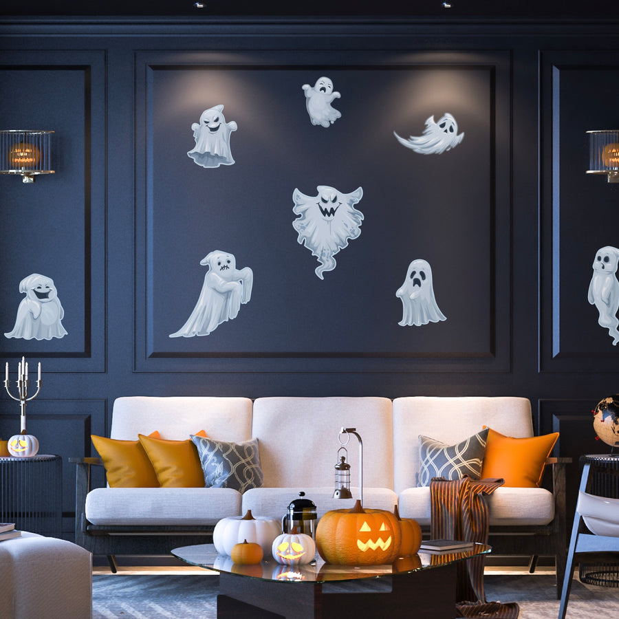 A living room decorated for halloween with ghosts and pumpkins.