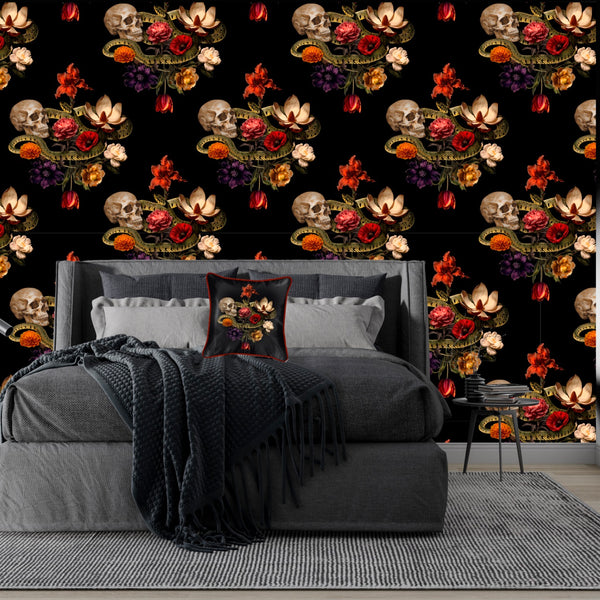 A bedroom adorned with a black floral and skull-patterned wallpaper, featuring a grey bed, the luxurious Dark Romance Silk Pillow Cushion with Cording by Contrado, and a grey blanket. The room is minimally decorated and has a hardwood floor.