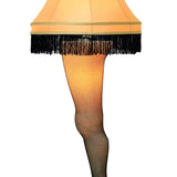 A decorative lamp designed to resemble a woman's leg wearing a black stiletto and fishnet stockings, topped with a fringed lampshade featuring A Christmas Story's Leg Lamp decals by Cover-Alls.