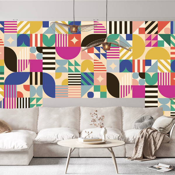 A modern living room with a beige sofa and round coffee table is set against Cover-Alls’ Bauhaus Tile Wallpaper, creating vibrant energy—ideal for anyone looking for striking tile wallpaper or contemporary wallpaper rolls.