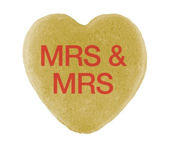 Gold heart-shaped object with "mrs & mrs" in red text, celebrating Pride Month - Candy Hearts for Pride by Cover-Alls.