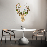 A small dining area with a round white table, two brown chairs, and a decorative Deer Head with Antlers, <br>Flowers and Birds from Cover-Alls on the wall above. A mug is placed on the table.