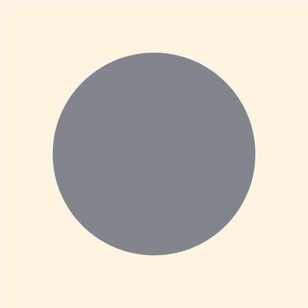 A simple graphic of a large grey polka dot Cover-Alls decal centered on a light beige background.