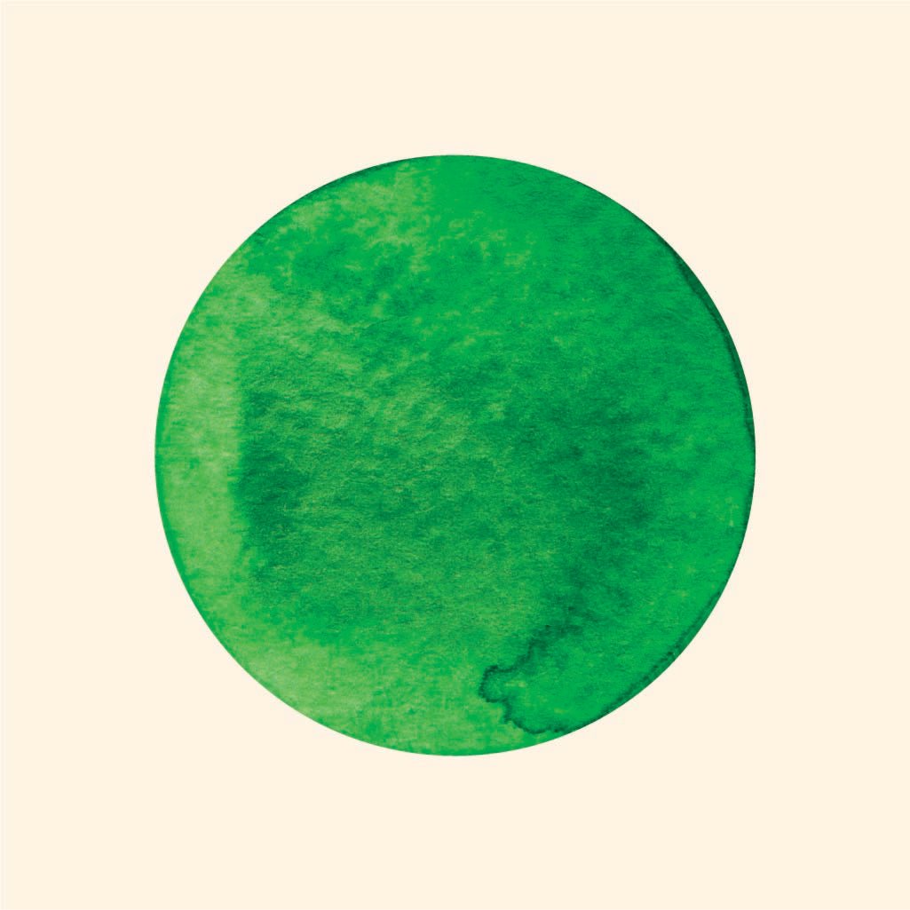 A circular, textured green Dot Decal from Cover-Alls centered on a vibrant pale yellow background.