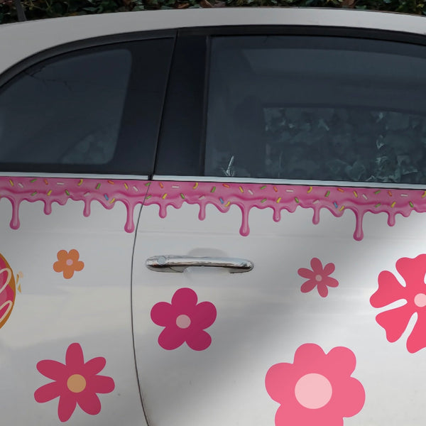 A white car with a Dripping Pink Icing with Confetti Sprinkles Decal and decorative strip along the side by Cover-Alls.