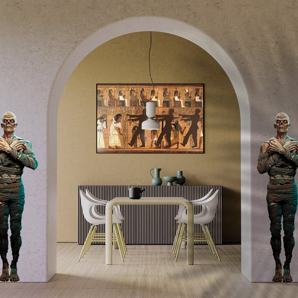 Two Egyptian Guard Mummy Zombie statues standing beside a dining table under an arched wall with an ancient Egyptian mural hanging above, transformed into Halloween decor by Cover-Alls.