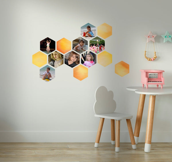 Cover-Alls honeycomb or hexagon shaped decals with diverse images on a wall, accompanied by a small table and chair with a toy piano and decorations.