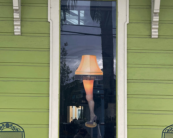 A window decorated with a CoverAlls' Leg Lamp decal, creating a festive atmosphere reminiscent of A Christmas Story's Leg Lamp.