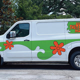 A white van with green and orange floral designs and the text 