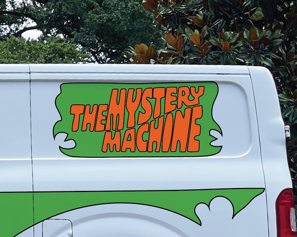 Side view of a white van with "Mystery Machine Kit" by Cover-Alls written in orange and green on the side, complete with custom decals reminiscent of Scooby Doo's iconic ride.