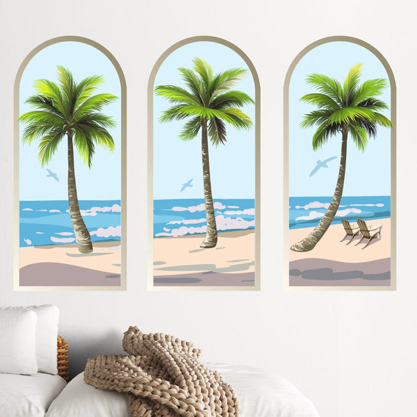Three vertical wall panels depicting palm trees at a beach, with a clear sky, ocean waves, and a hammock in one panel as calming environment decor. The Palm Tree Arch Scene Decals by Cover-Alls.