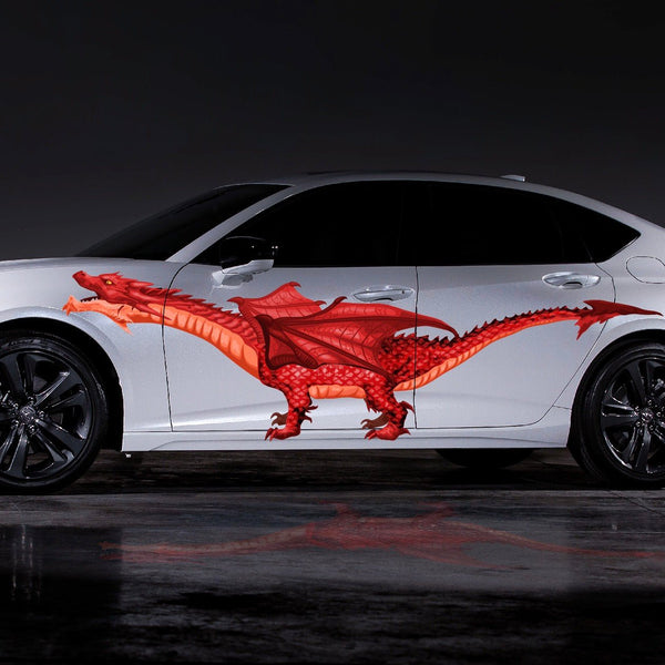 A white sedan with a vibrant Cover-Alls Red Dragon car decoration along its side, parked on a wet surface under dim lighting.