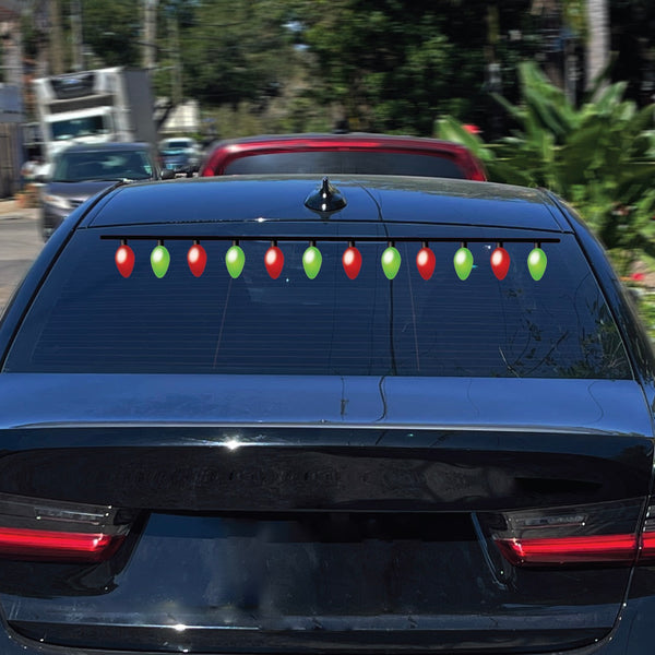 The rear window of a black car is adorned with green and red decorative lights, enhanced by Cover-Alls' Christmas Lights Decals, spreading holiday cheer wherever it goes.