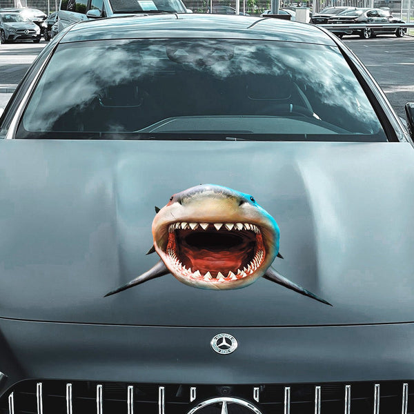 Front view of a gray Mercedes-Benz car with an edited image of Cover-Alls Scary Shark Decals on its hood, parked in a city setting.