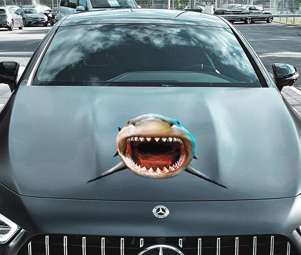 Front view of a gray Mercedes-Benz car with an edited image of Cover-Alls Scary Shark Decals on its hood, parked in a city setting.