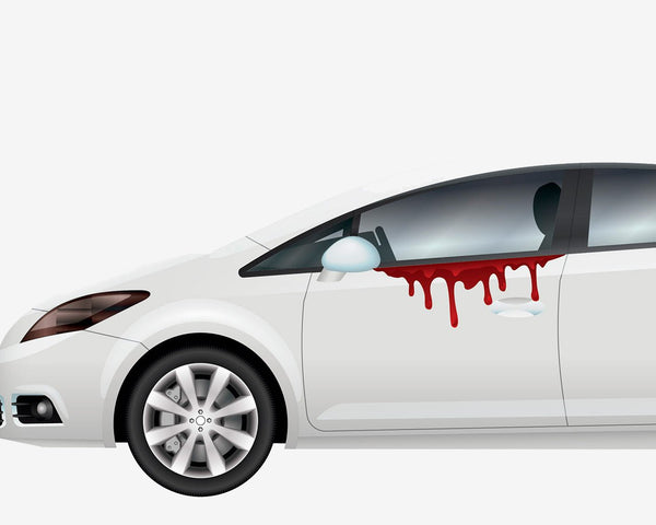 A white car with a Halloween themed decal dripping from the window.