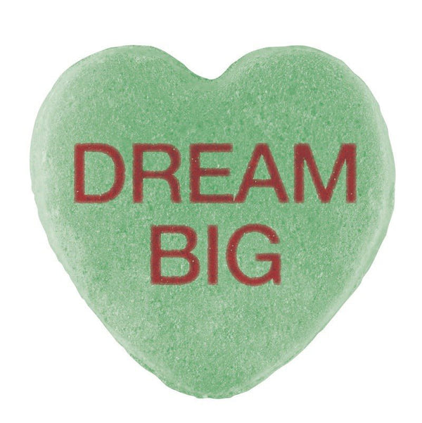 A green heart-shaped Candy Hearts with the phrase "dream big" printed in red letters, featuring a Cover-Alls design.