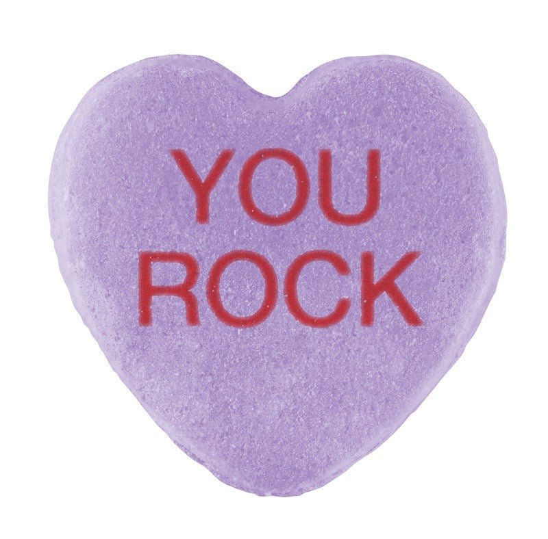 A purple heart-shaped Candy Hearts with "you rock" stamped in red text, isolated on a white background for Valentine's Day.
