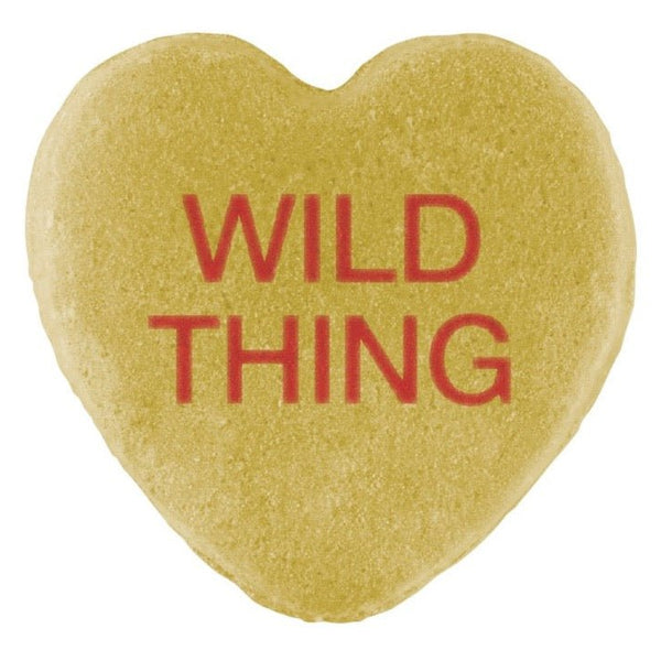 A heart-shaped cookie with "wild thing" written in red icing, perfect for Valentine's Day from Cover-Alls Candy Hearts.