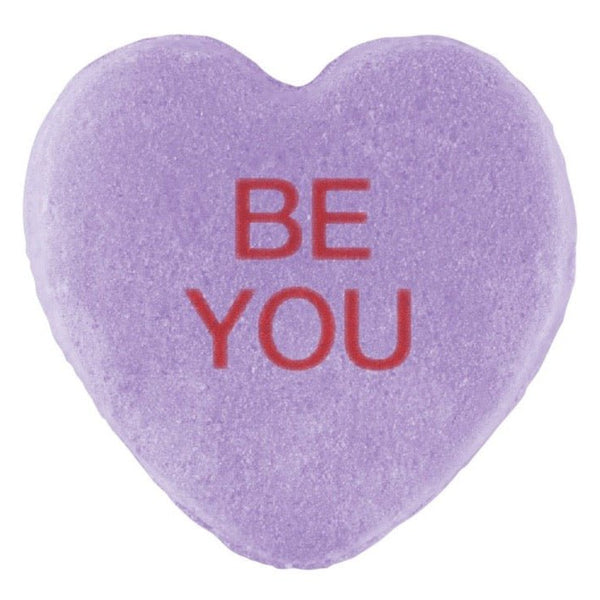 A purple heart-shaped Candy Hearts with the phrase "be you" printed in red letters, perfect for Valentine's Day.