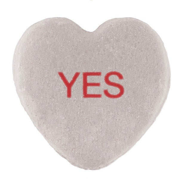 A Candy Hearts with a CUSTOM design, featuring a textured white surface and the word "yes" printed in red in the center by Cover-Alls.