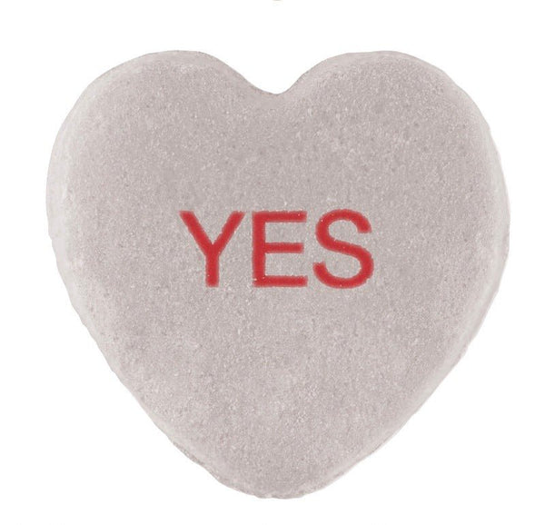 A Candy Hearts with a CUSTOM design, featuring a textured white surface and the word "yes" printed in red in the center by Cover-Alls.