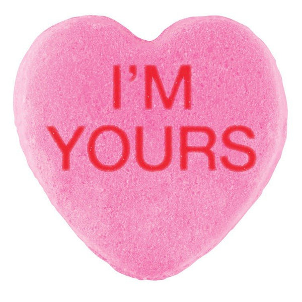 A pink heart-shaped candy with the phrase "i'm yours" embossed in red letters, perfect for Valentine's Day. Candy Hearts by Cover-Alls.