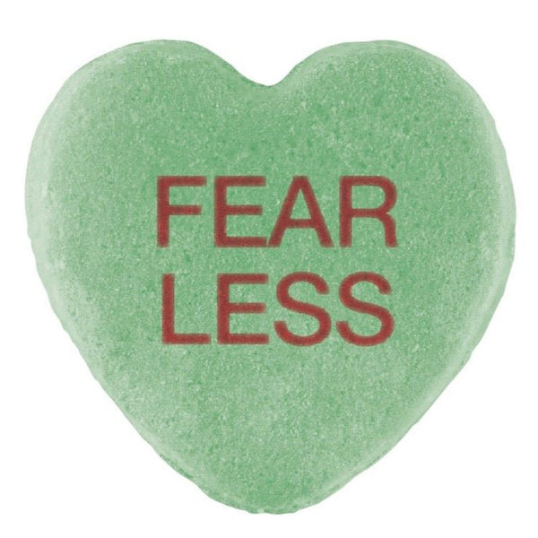 Green heart-shaped Candy Hearts with the words "fear less" printed in red, perfect for Valentine's Day by Cover-Alls.