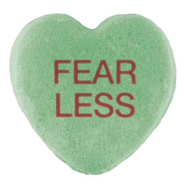 Green heart-shaped Candy Hearts with the words "fear less" printed in red, perfect for Valentine's Day by Cover-Alls.