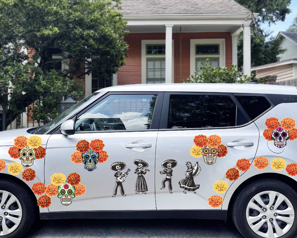 A white Day of the Dead Mariachi Band suv is decorated with sugar skulls and flowers, featuring a Halloween themed decal.