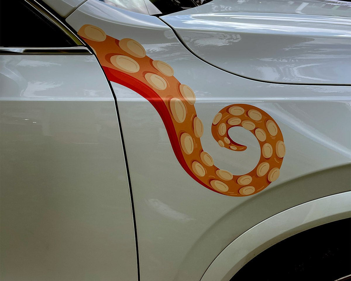 A white car with Eight Terrifying Tentacle Decals from CoverAlls on the hood, featuring Halloween themed decals.