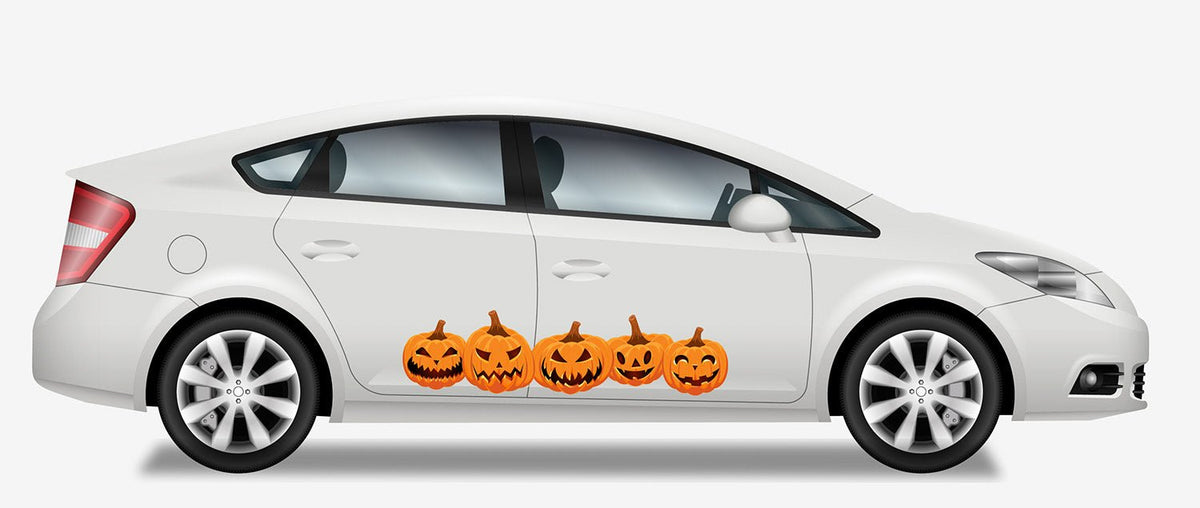 A white sedan decorated with a row of Cover-Alls Jack O' Lantern Pumpkin Decals on the side, showcasing different jack-o'-lantern faces.